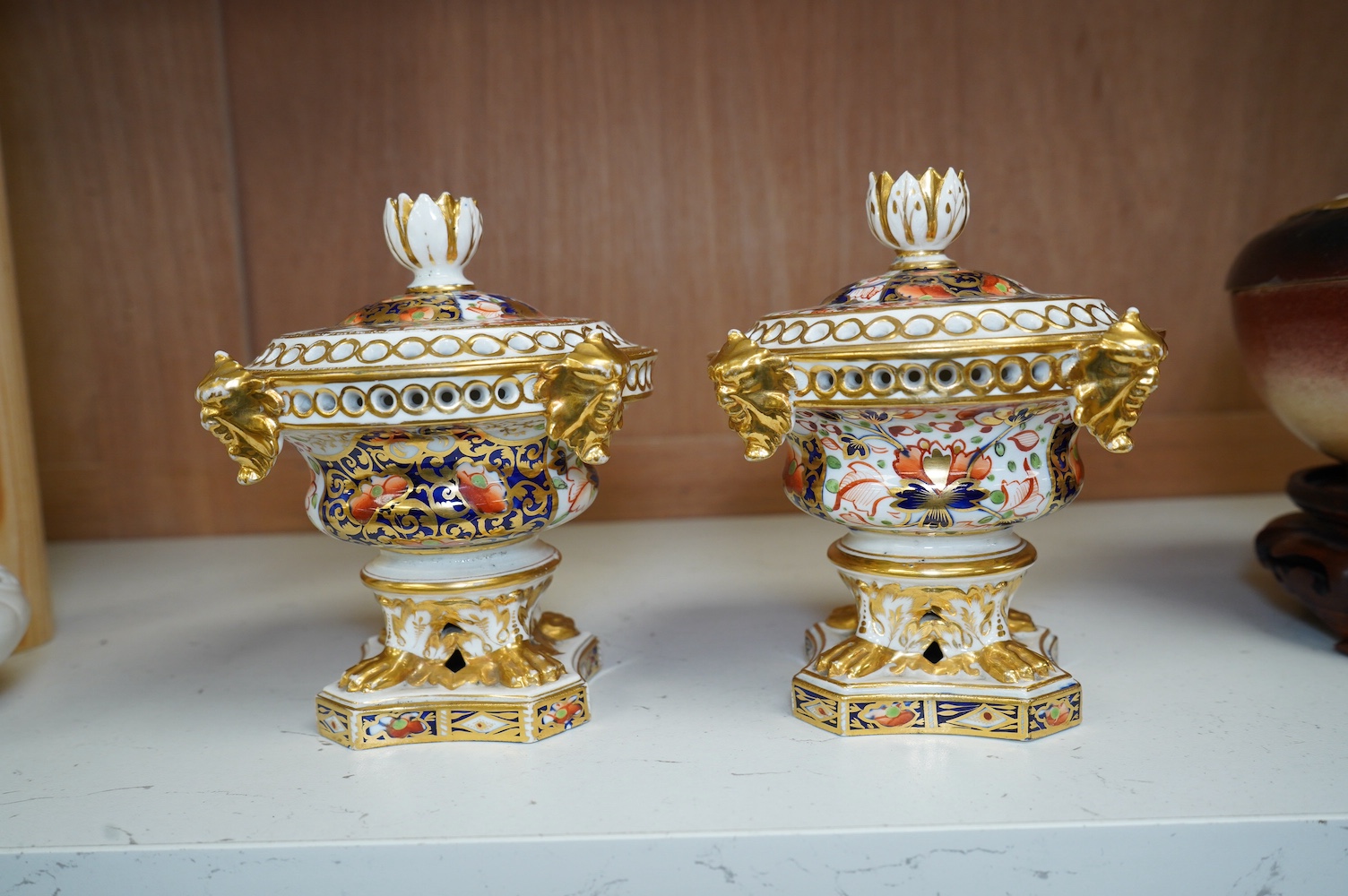 A pair of Derby Imari pattern pot pourri pots and covers, 14cm high. Condition - gilding worn in places and one pot has two fine cracks to interior top edge and flower, a few finial petals are damaged